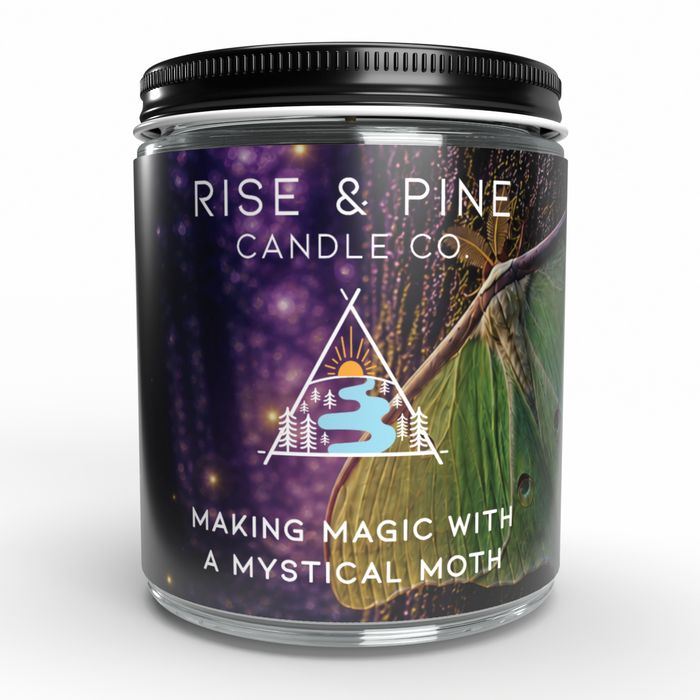 A glass jar candle with a black metal lid and a dark label featuring a purple starry background, a green moth wing, and white text reading 'RISE & PINE CANDLE CO.' and 'MAKING MAGIC WITH A MYSTICAL MOTH'.