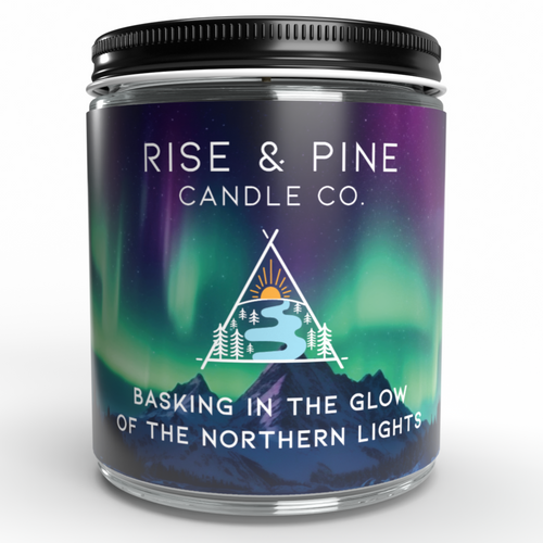 Candle jar with 'Rise & Pine Candle Co.' label featuring Northern Lights design on a white background