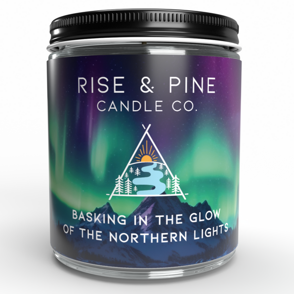 Candle jar with 'Rise & Pine Candle Co.' label featuring Northern Lights design on a white background
